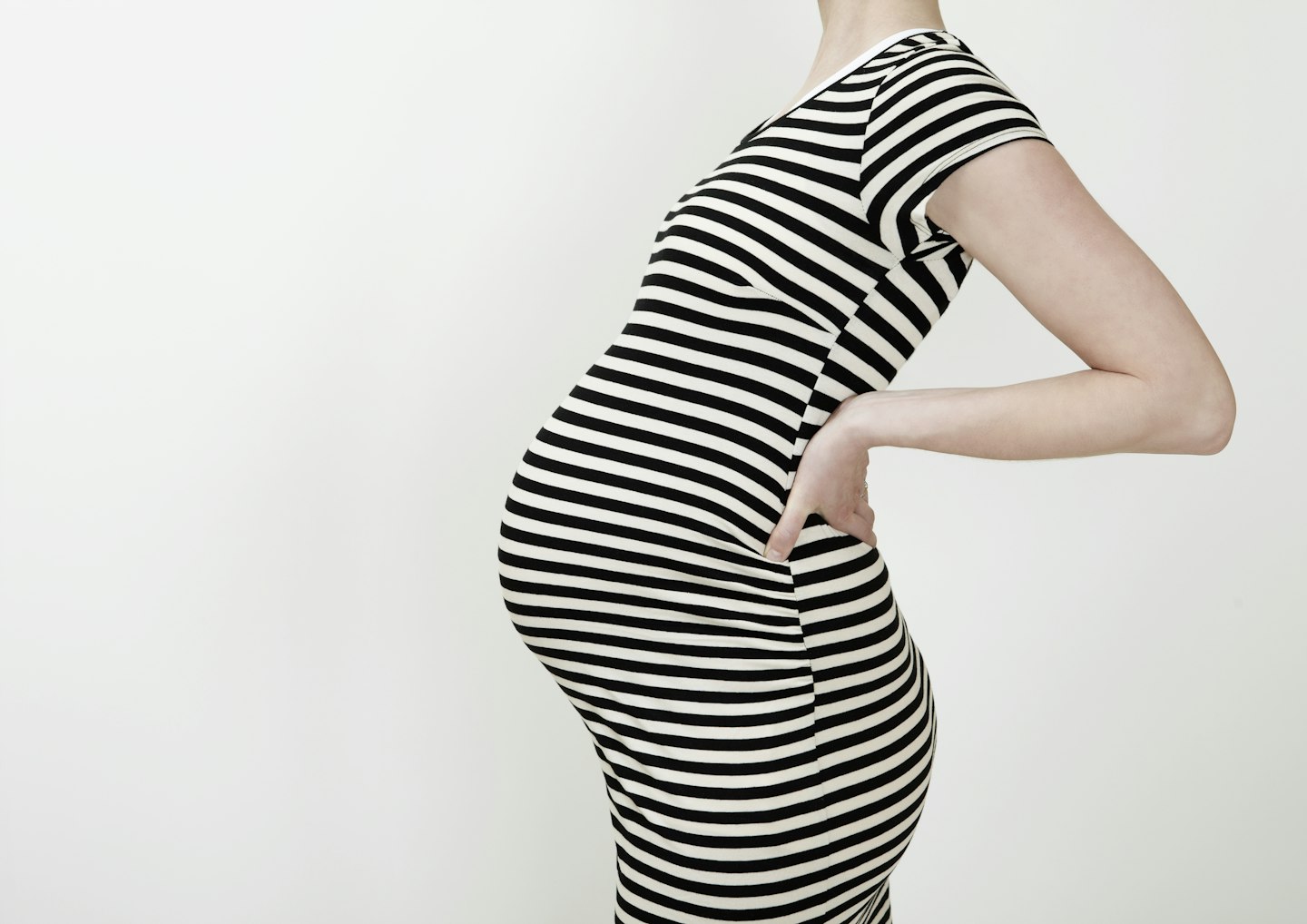 Pregnant woman holding her back