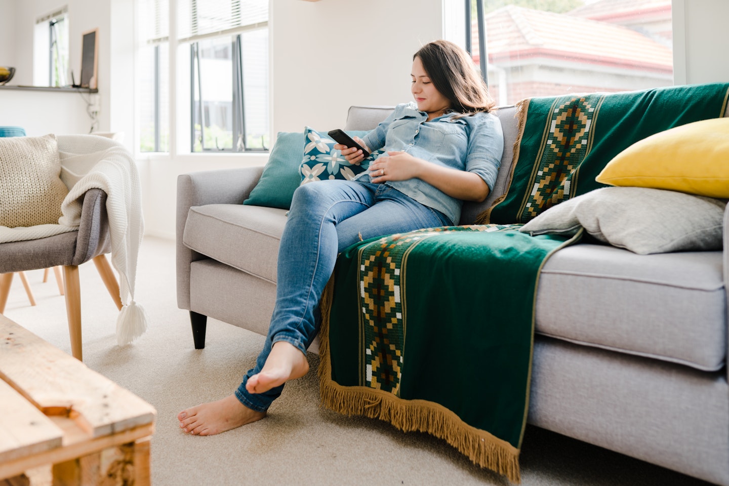 Pregnant woman sat on the sofa