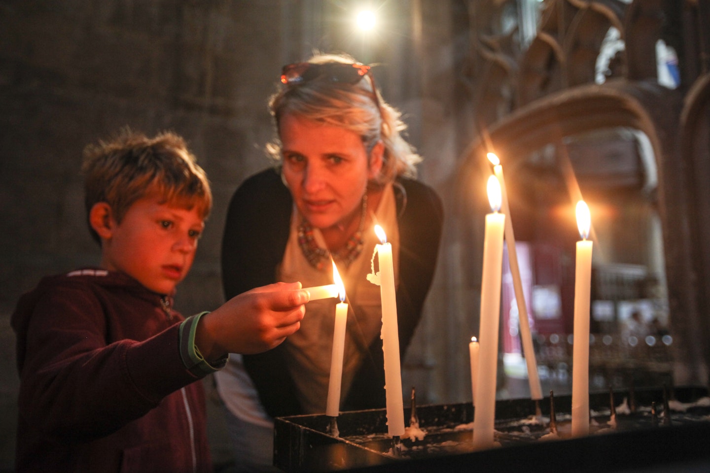 kid and lady lighting candles