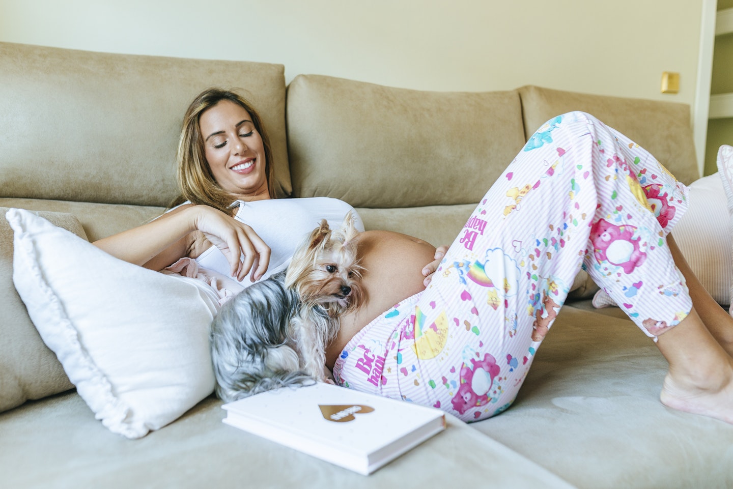 Pregnant woman relaxing with her dog