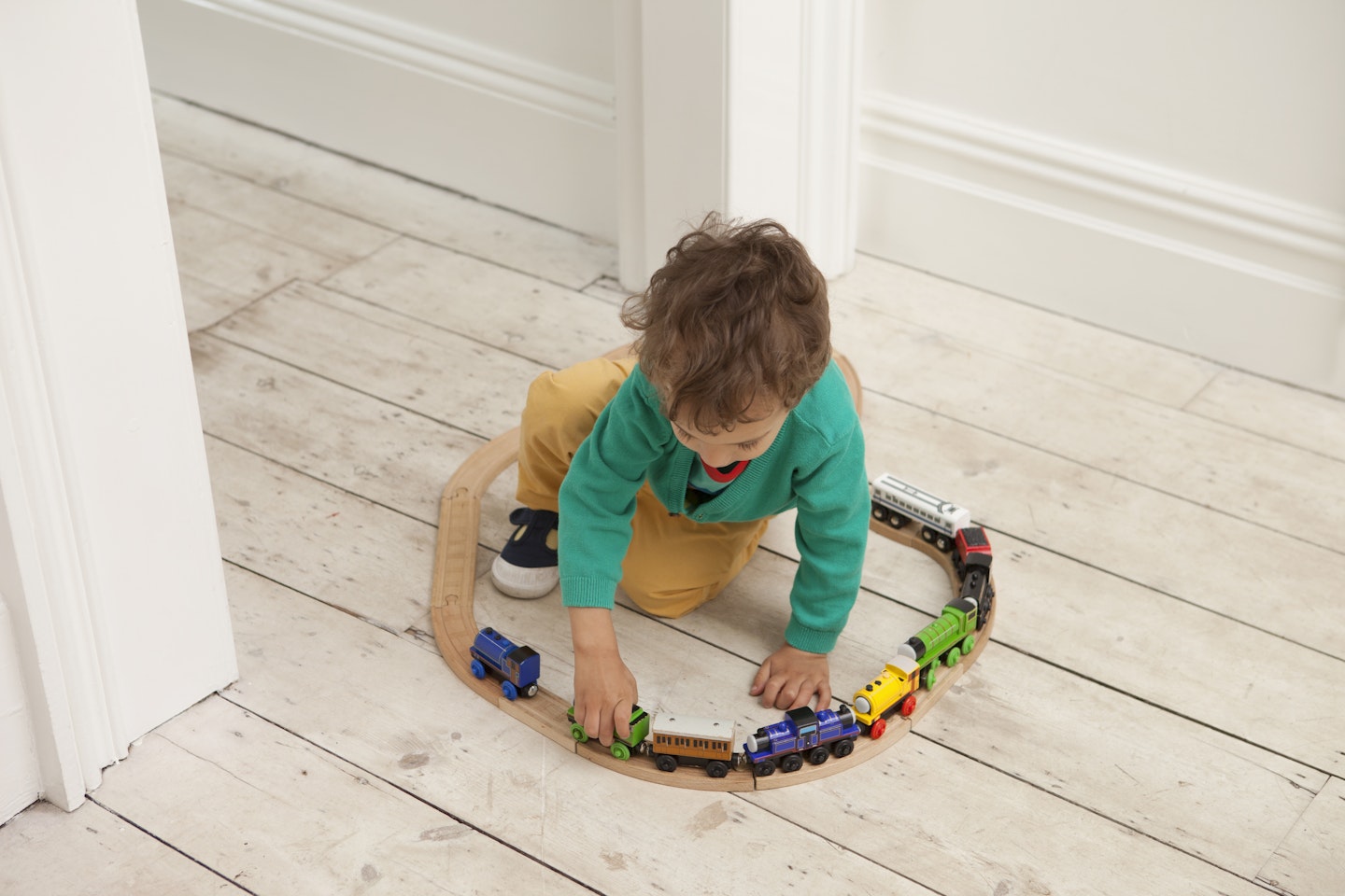 Toddler playing with train set