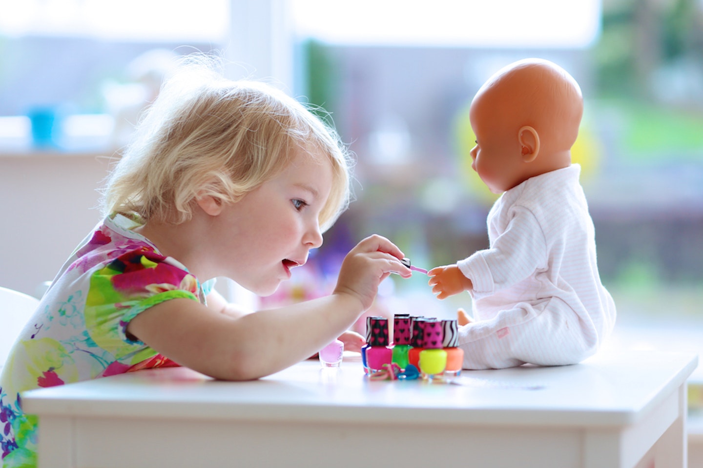 toddler playing with doll