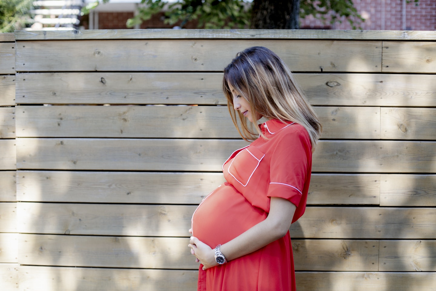 Woman outside holding her bump