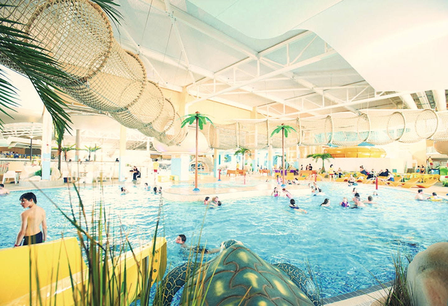 A large pool with slides and trees at Butlins Skegness