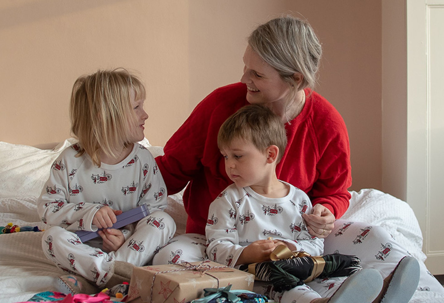 Family unwrapping christmas presents