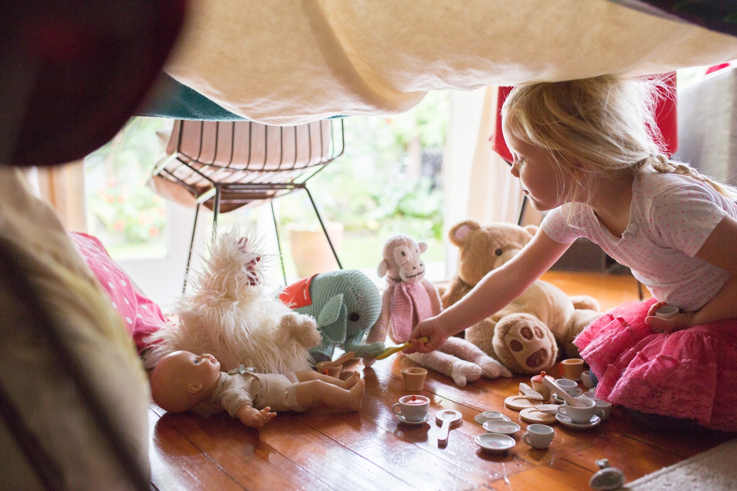 child having tea party with toys
