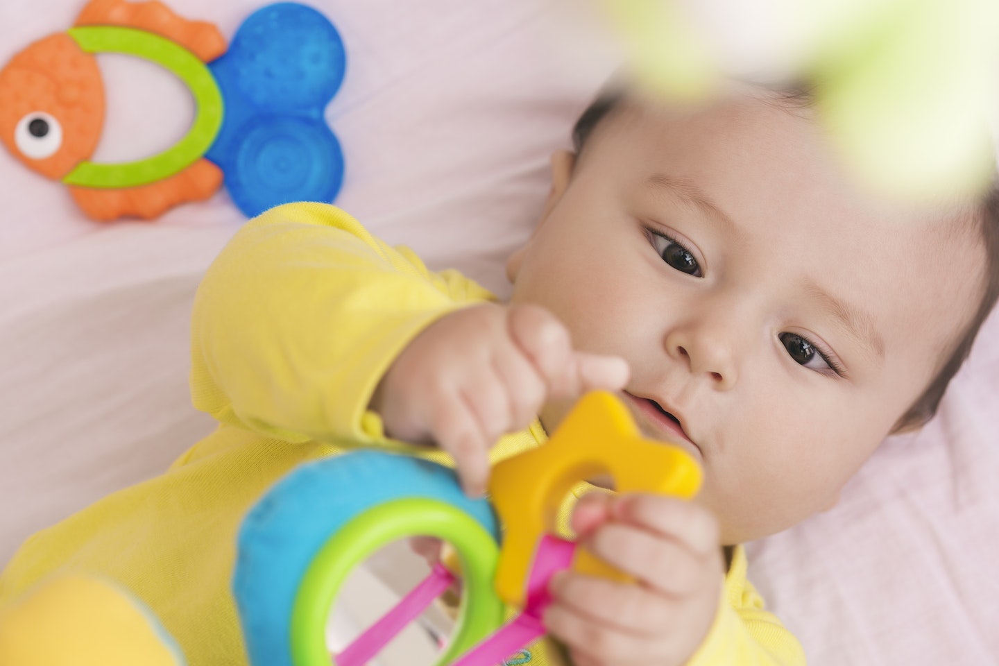 baby playing with teething toy