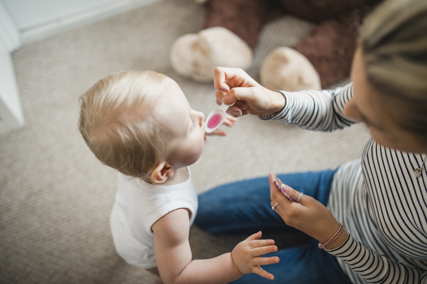 mum giving baby Calpol