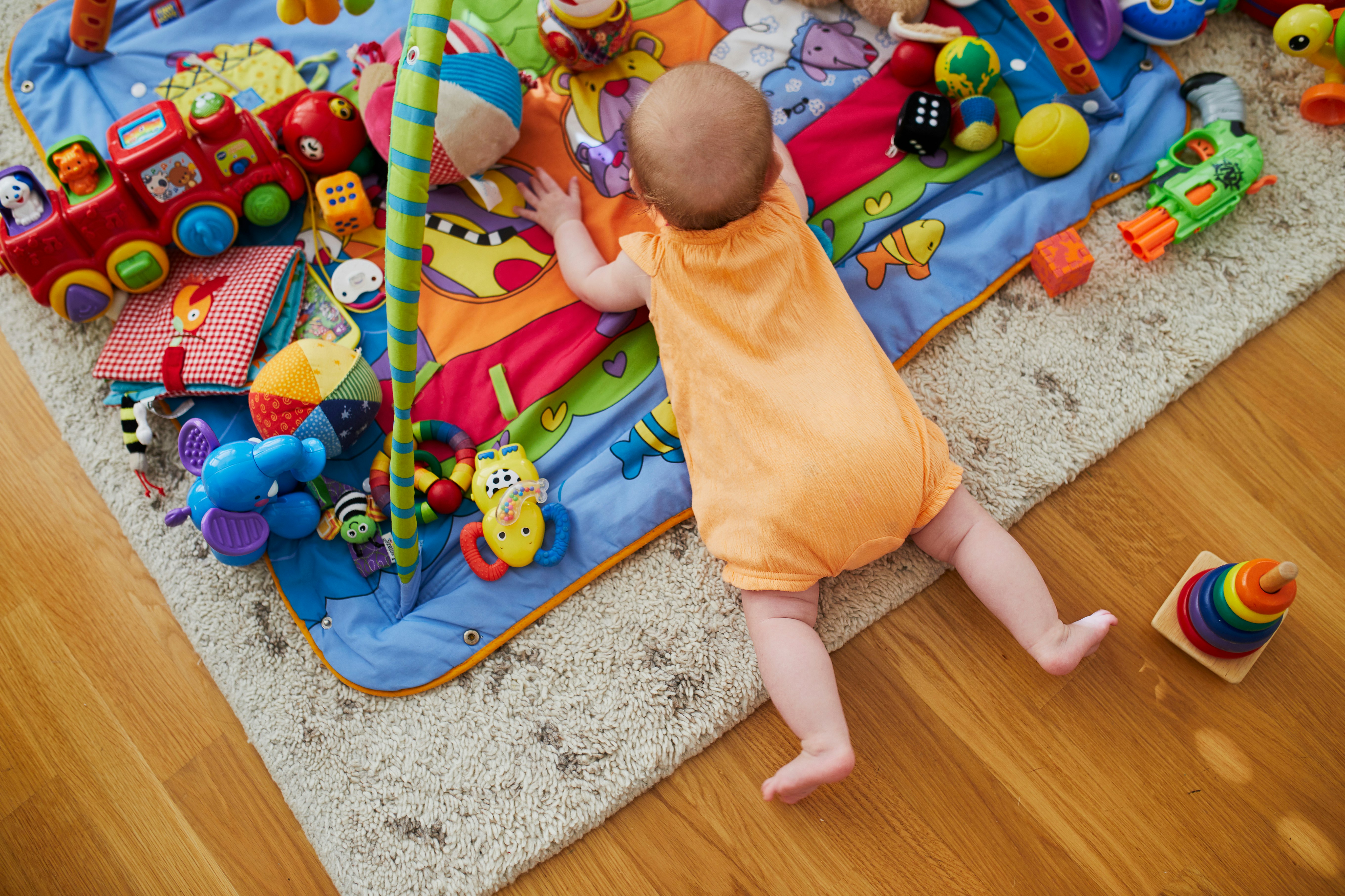 Baby playing on a playmate and having tummy time