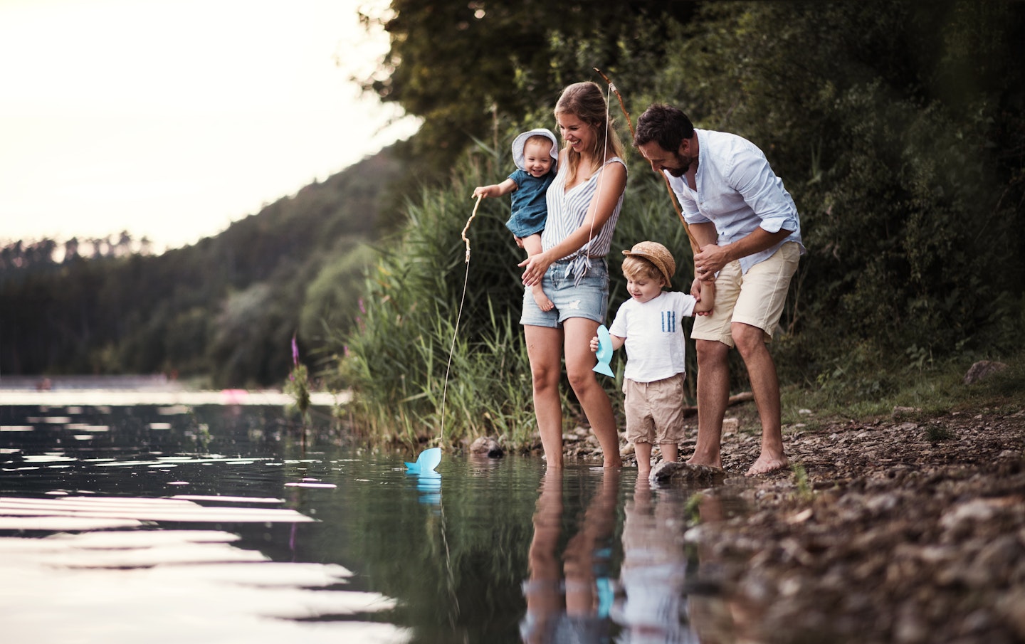 Family playing by a lake