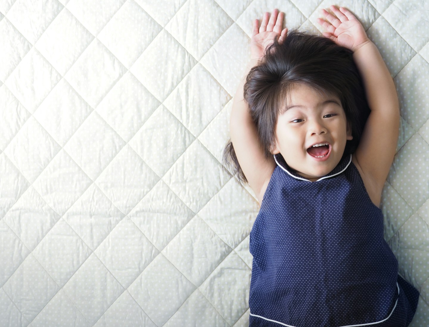 toddler on mattress bed