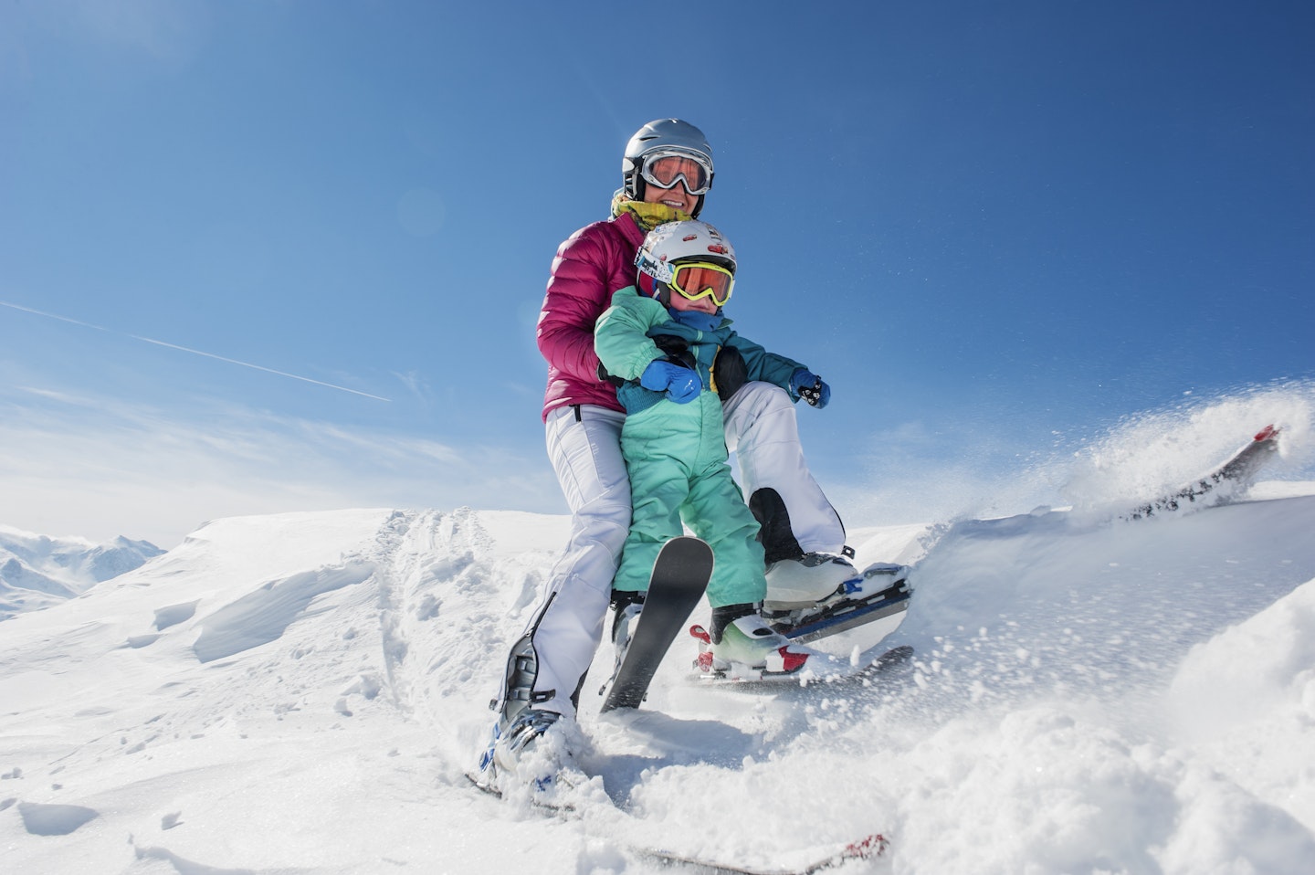 Mother and child skiing