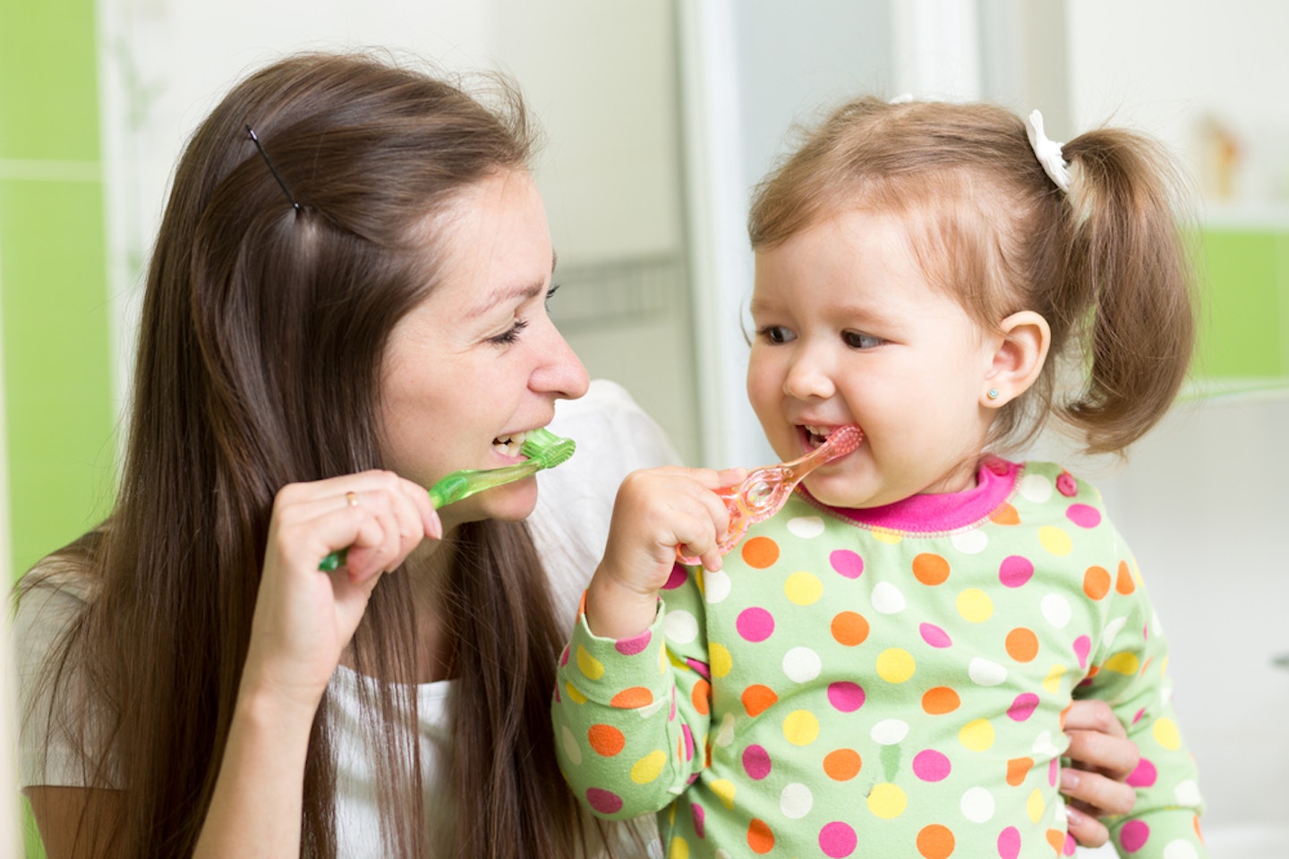 Mum and daughter brushing their teeth together