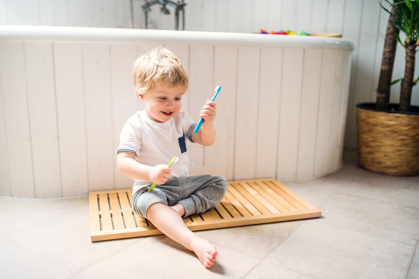 Toddler holding his toothbrush