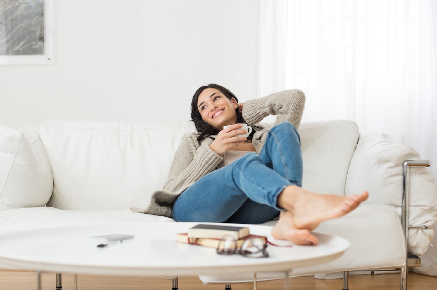 woman sitting on the sofa with drink