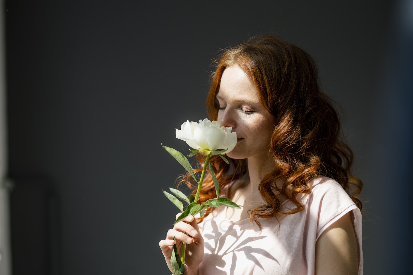 woman smelling flower