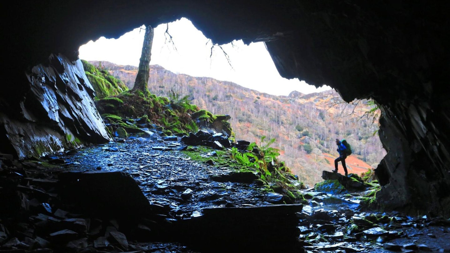 Walker in Millican Dalton's cave in Borrowdale in the Lake District
