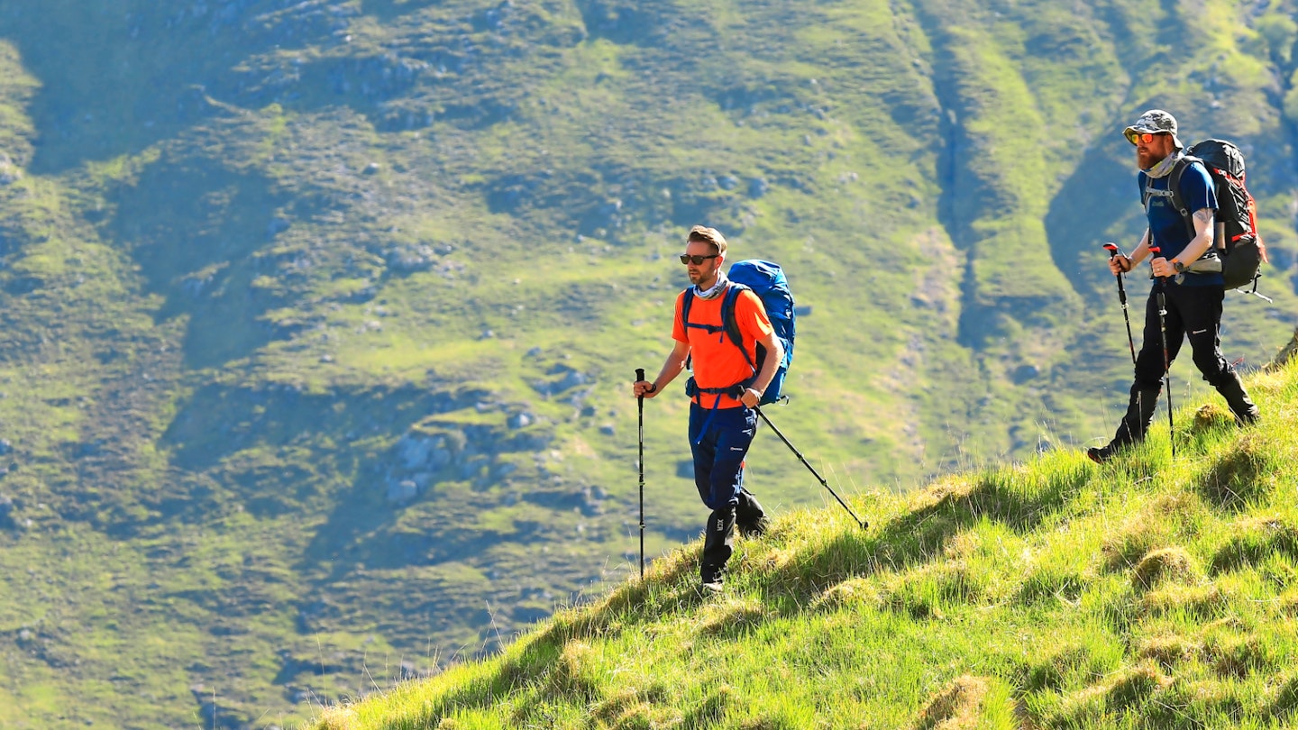 Two hikers wearing backpacking backpacks on Creag Bheithe Knoydart Scotland