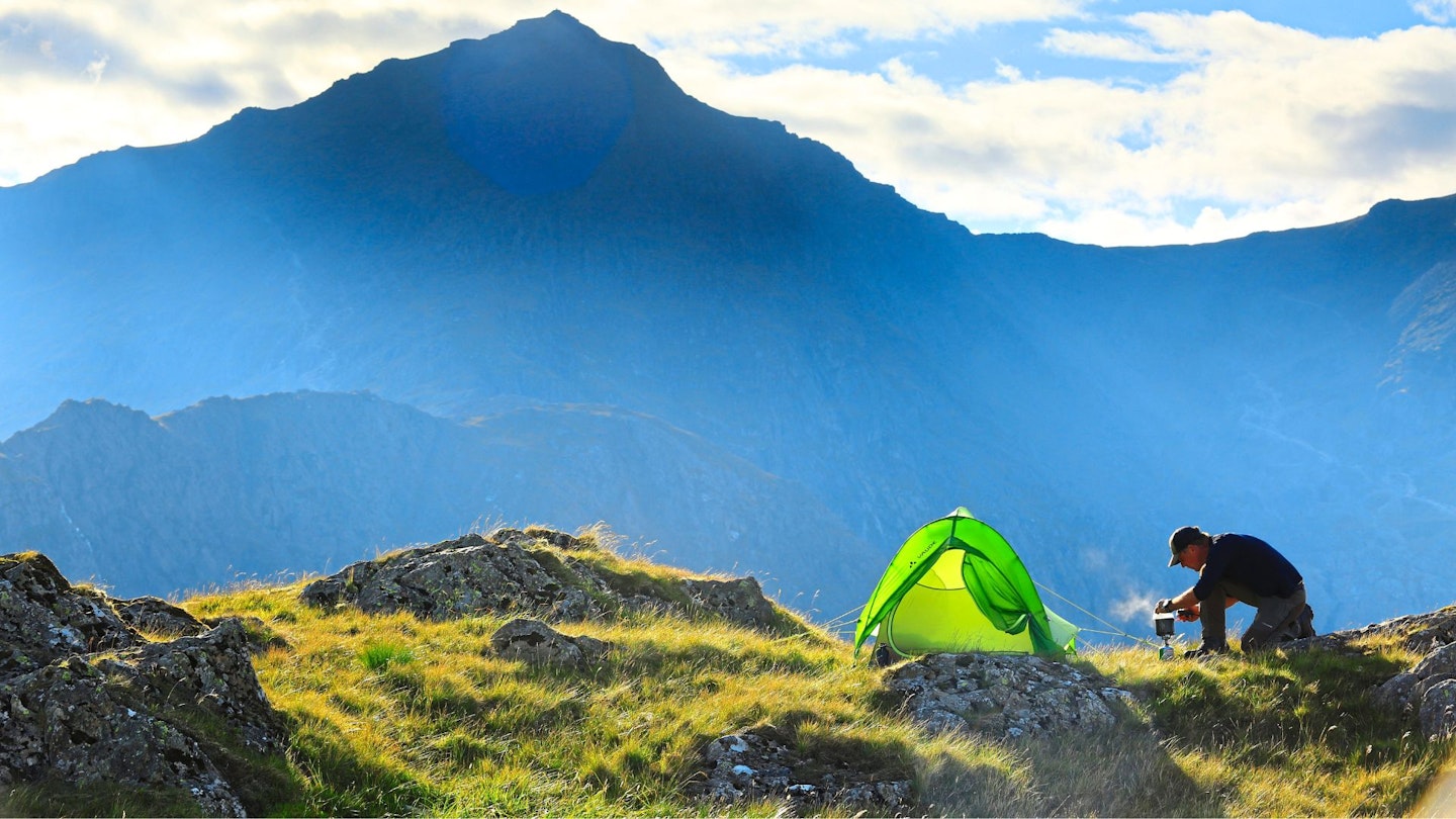 Hiker making camp with their one person tent