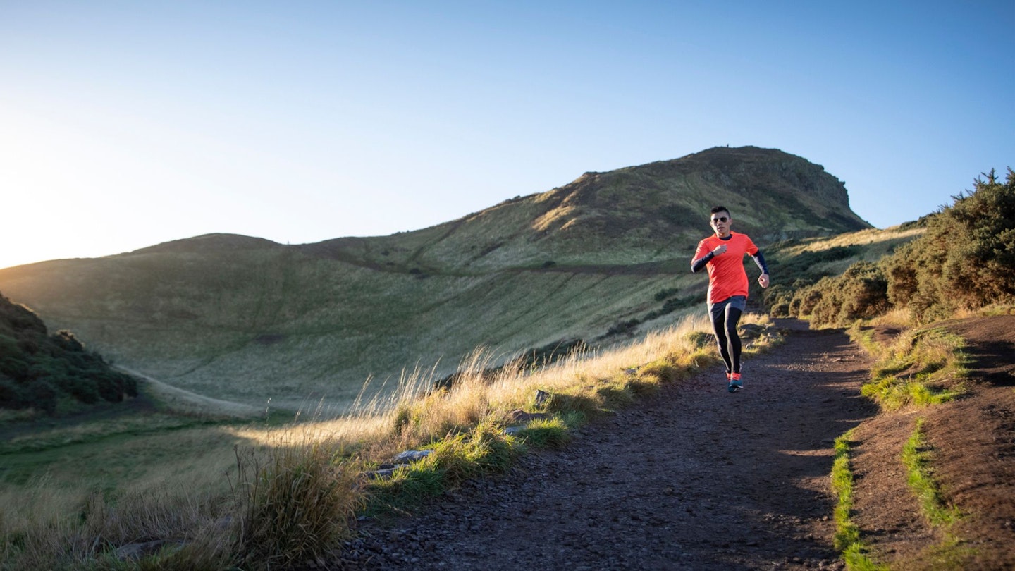 Man trail running in UK hills in summer