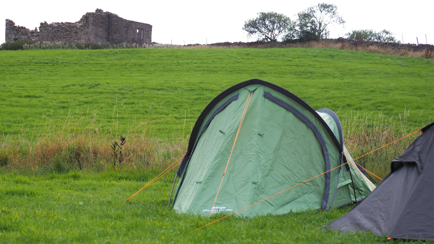 Vango Helvellyn 200 tent pitched with an old farm building in the background