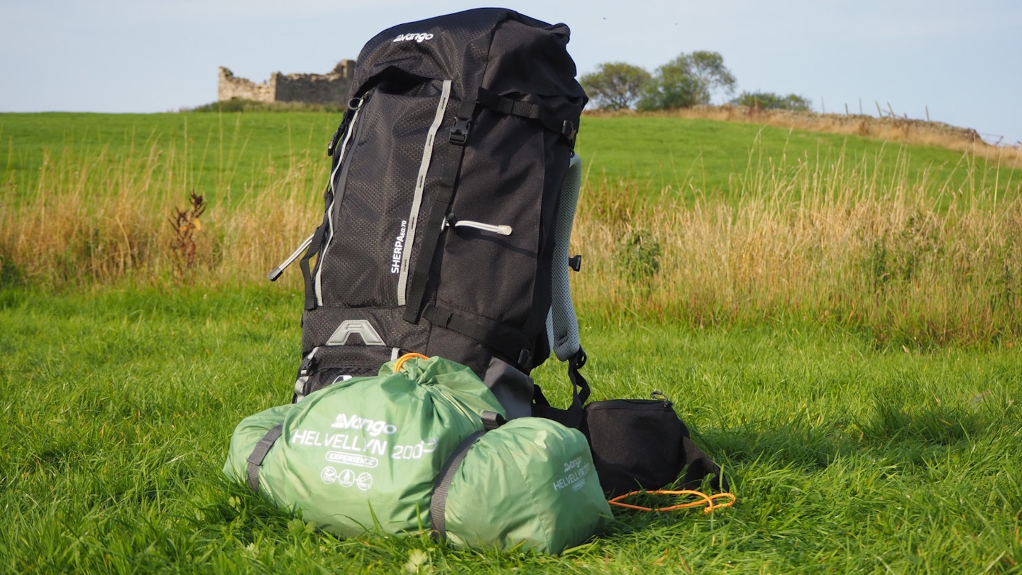 Vango Helvellyn 200 packed in bag and sitting next to a hiking pack