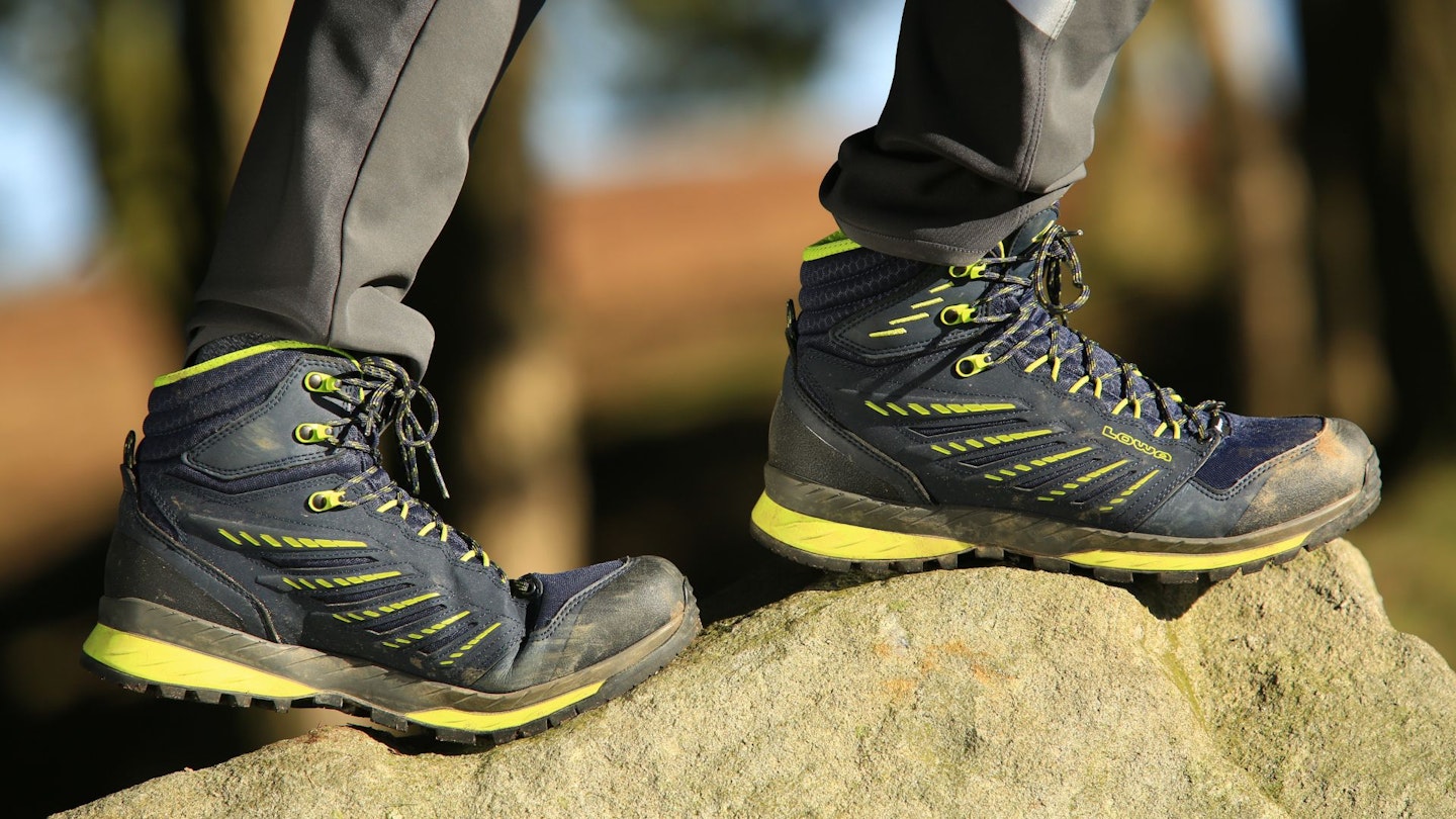 Flexing walking boot standing on a rock