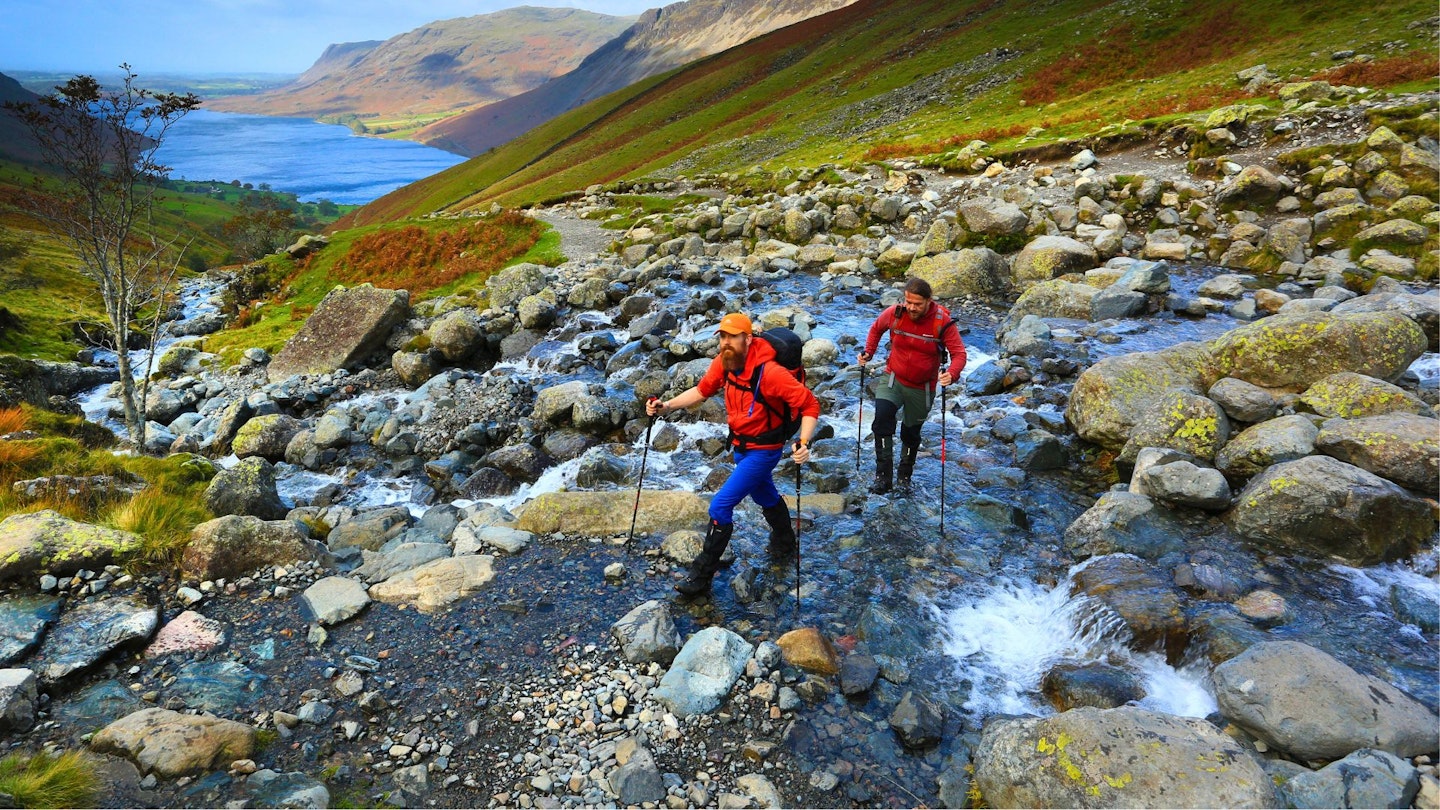 Hikers crossing a stream