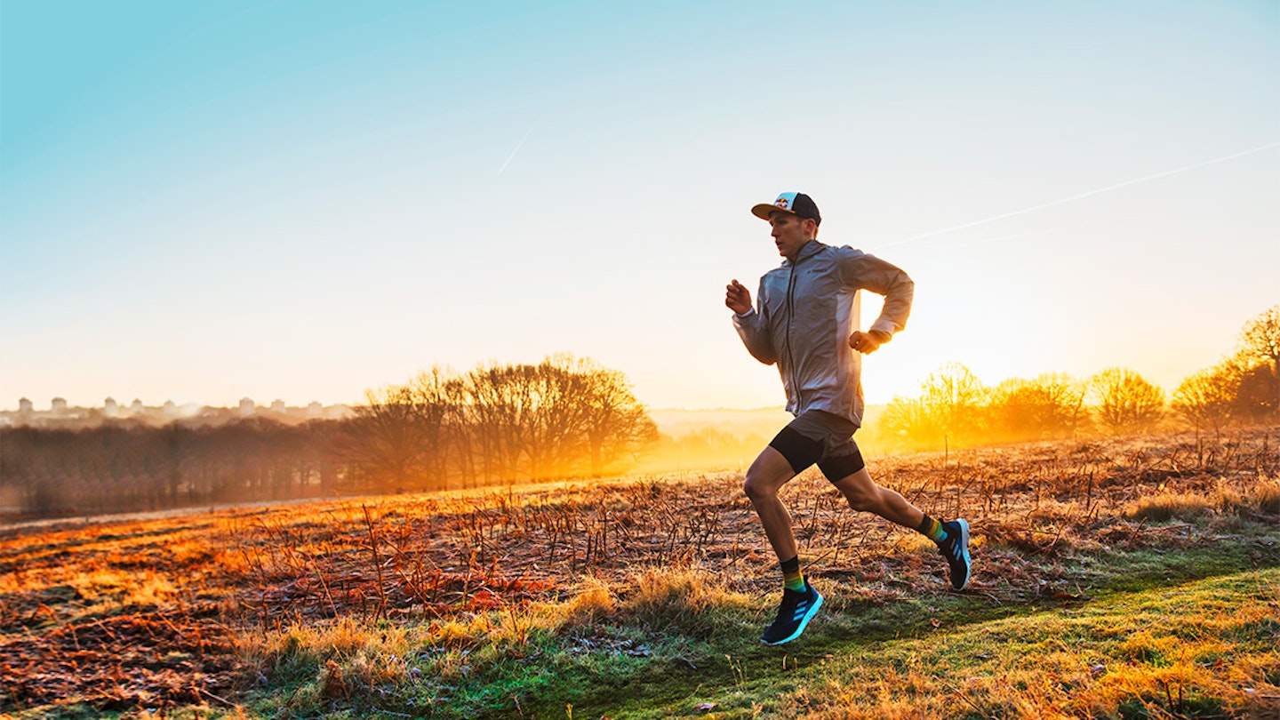 tom evans runs along a trail in the sunset