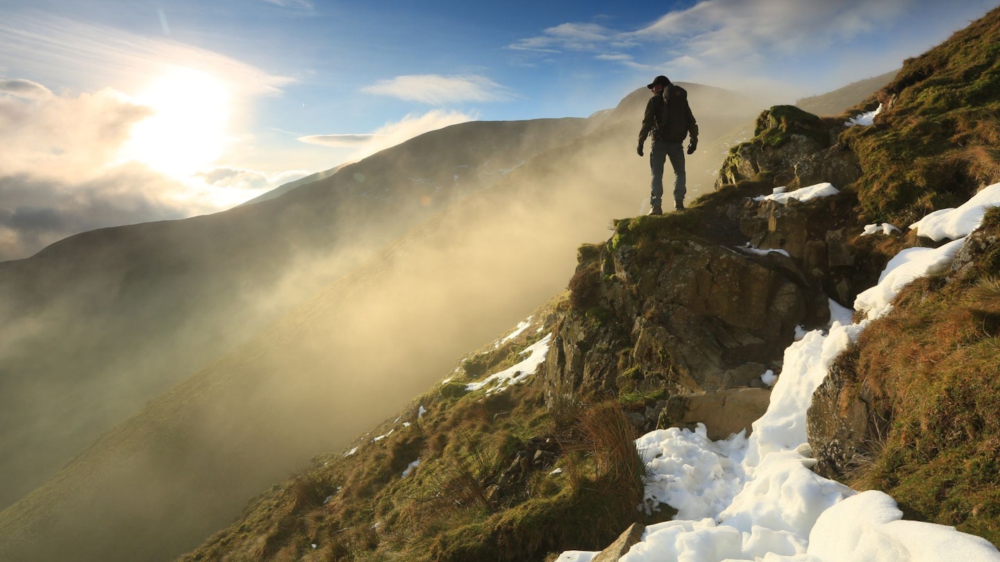 A hiker standing on precipice at Cautley Spout