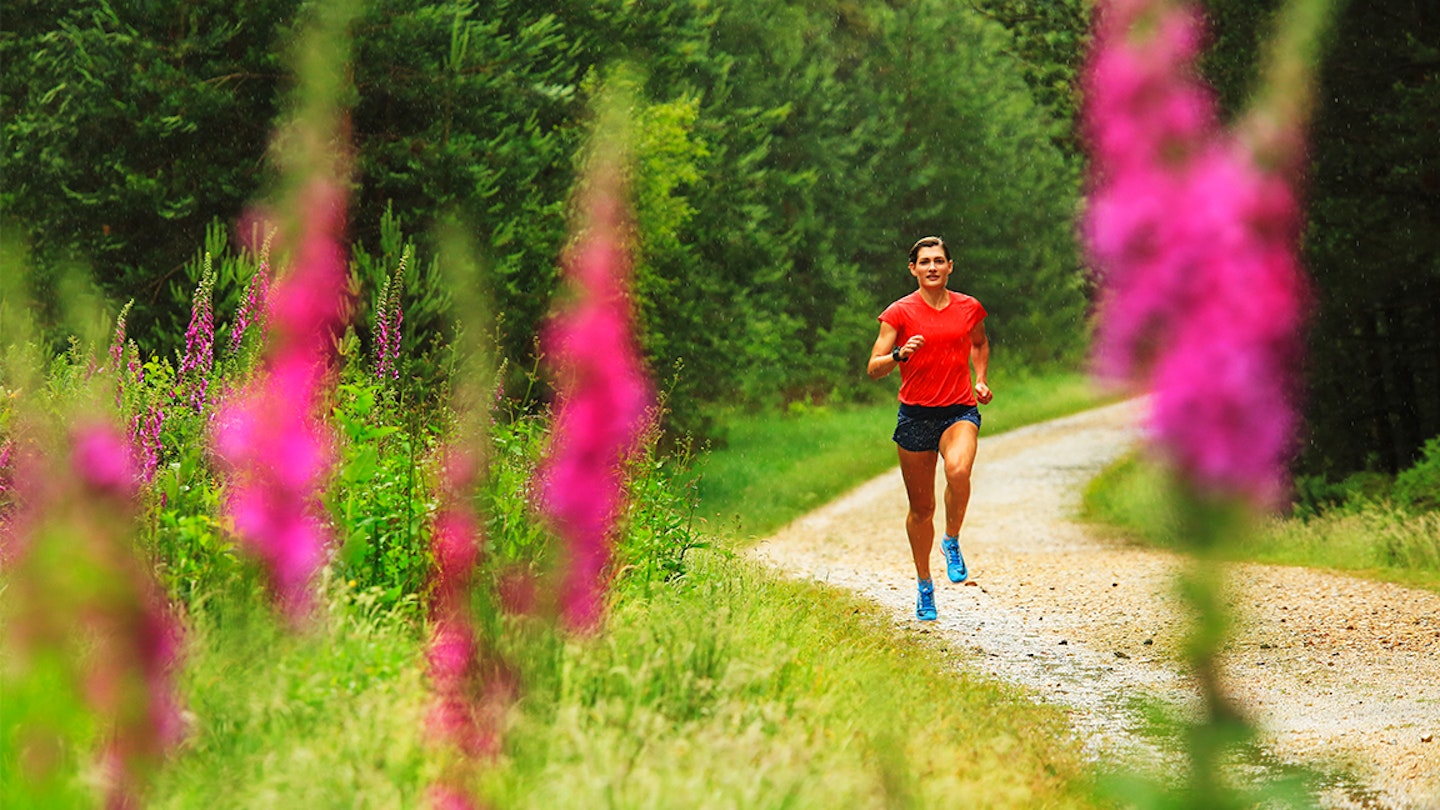 women runs through forest park