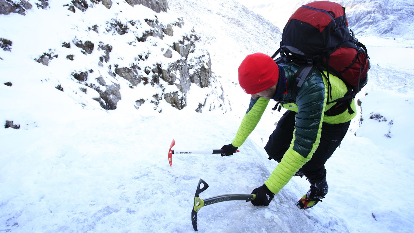 Hiker climbing Ice Step in Snowdonia wearing insulated jacket