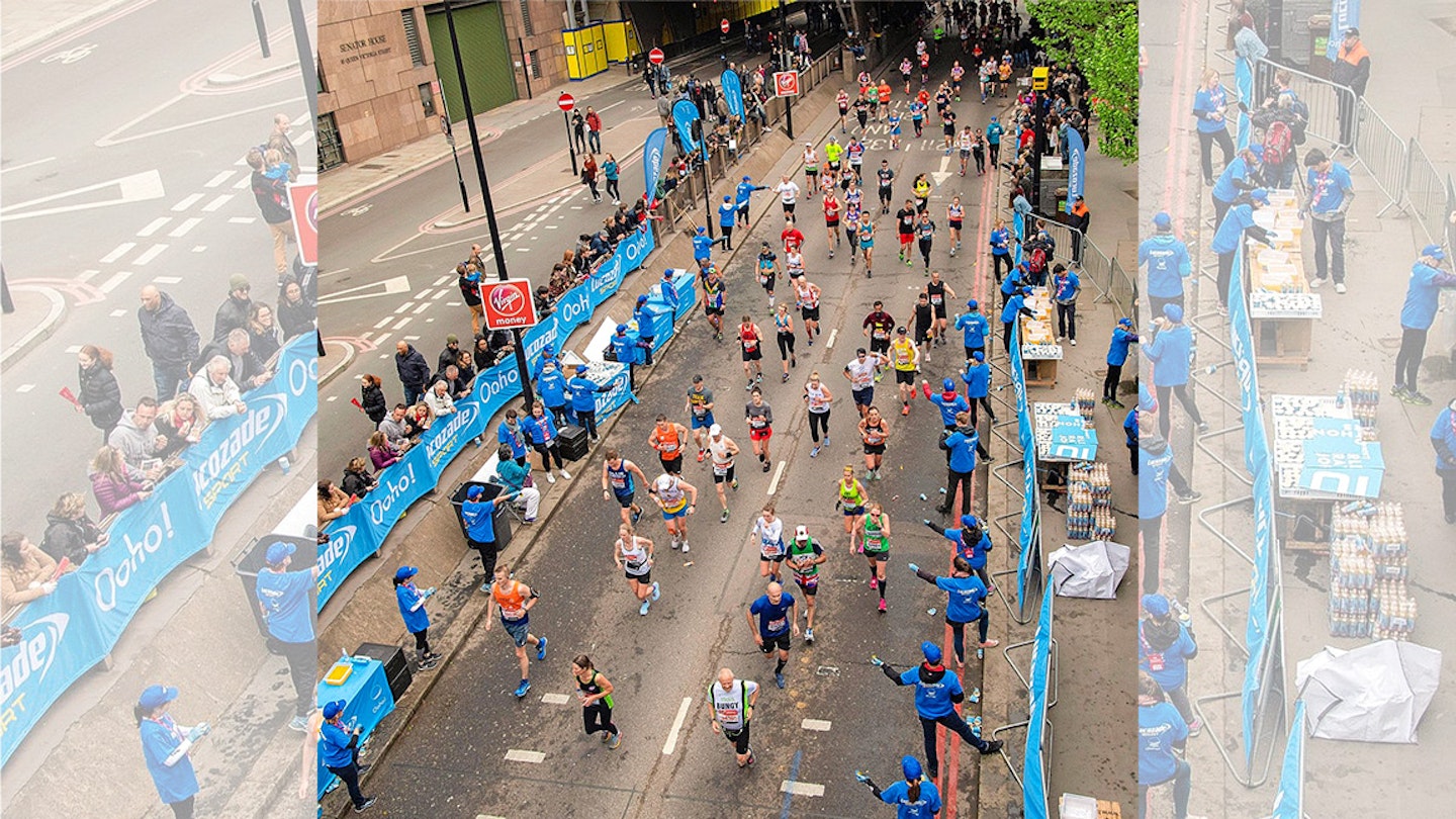 london marathon runners refuelling at an aid station