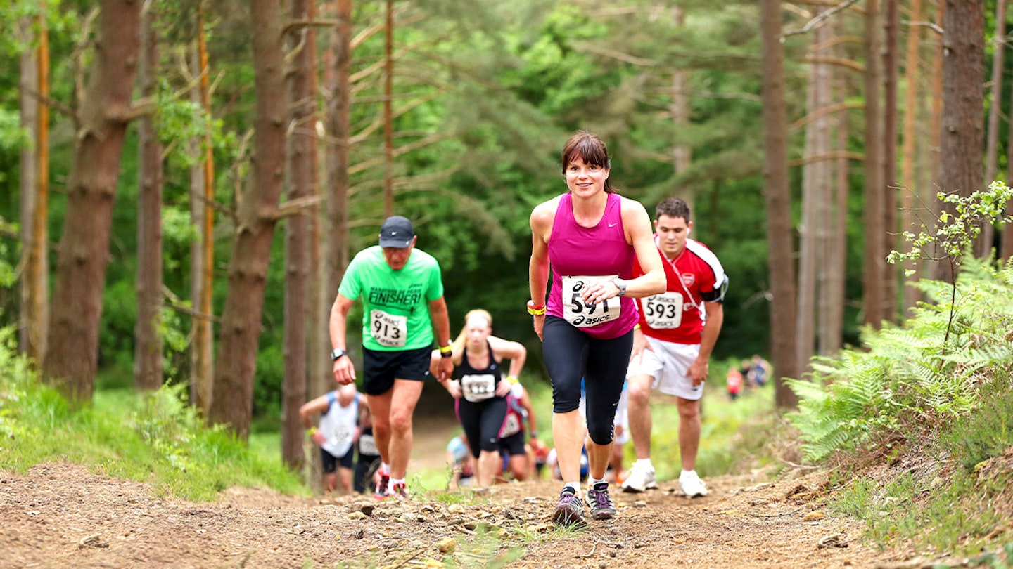 runners in a forest during a trail race