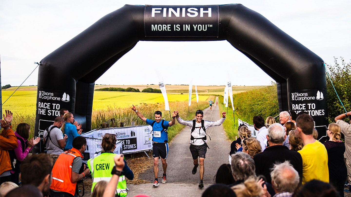 two men run across finish line of race across the stones ultra