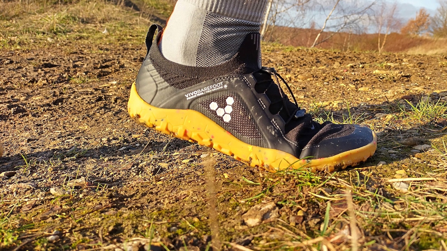 Runner wearing Vivobarefoot Primus Trail Knit FG