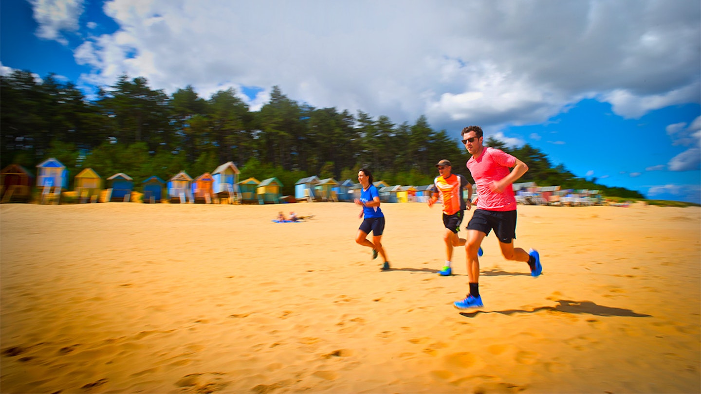 runners along a beach