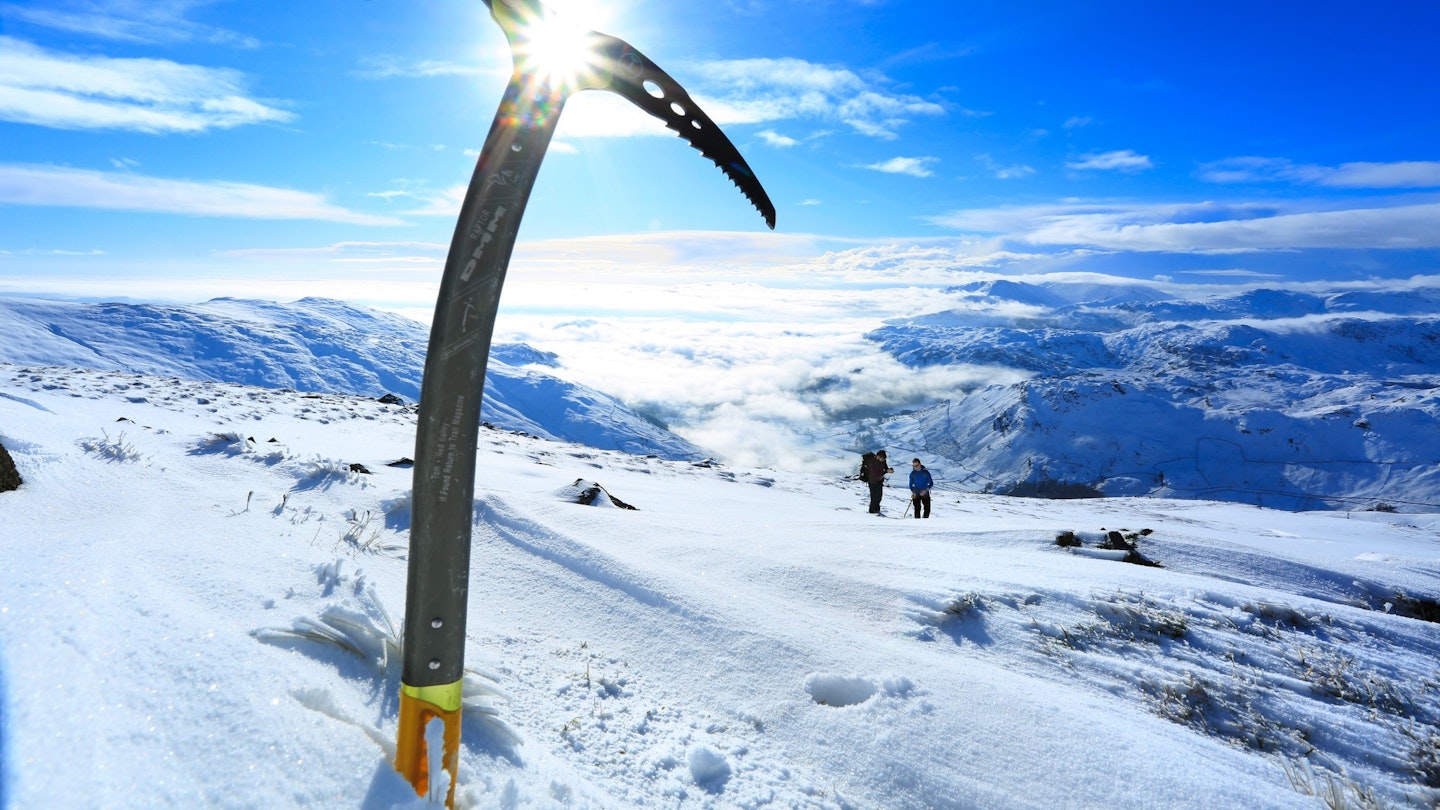 Ice axe sticking out of the snow, Lake District