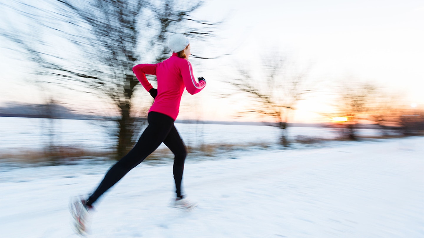 woman in pink runs on snow