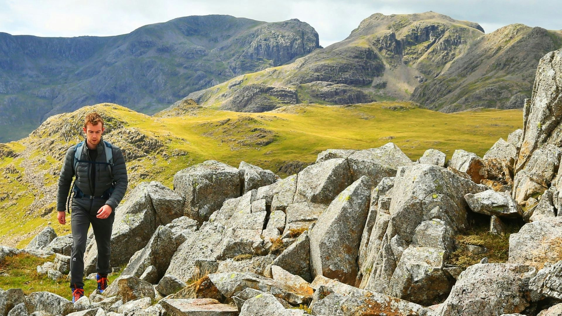 Hiker walking wearing a lightweight insulated jacket