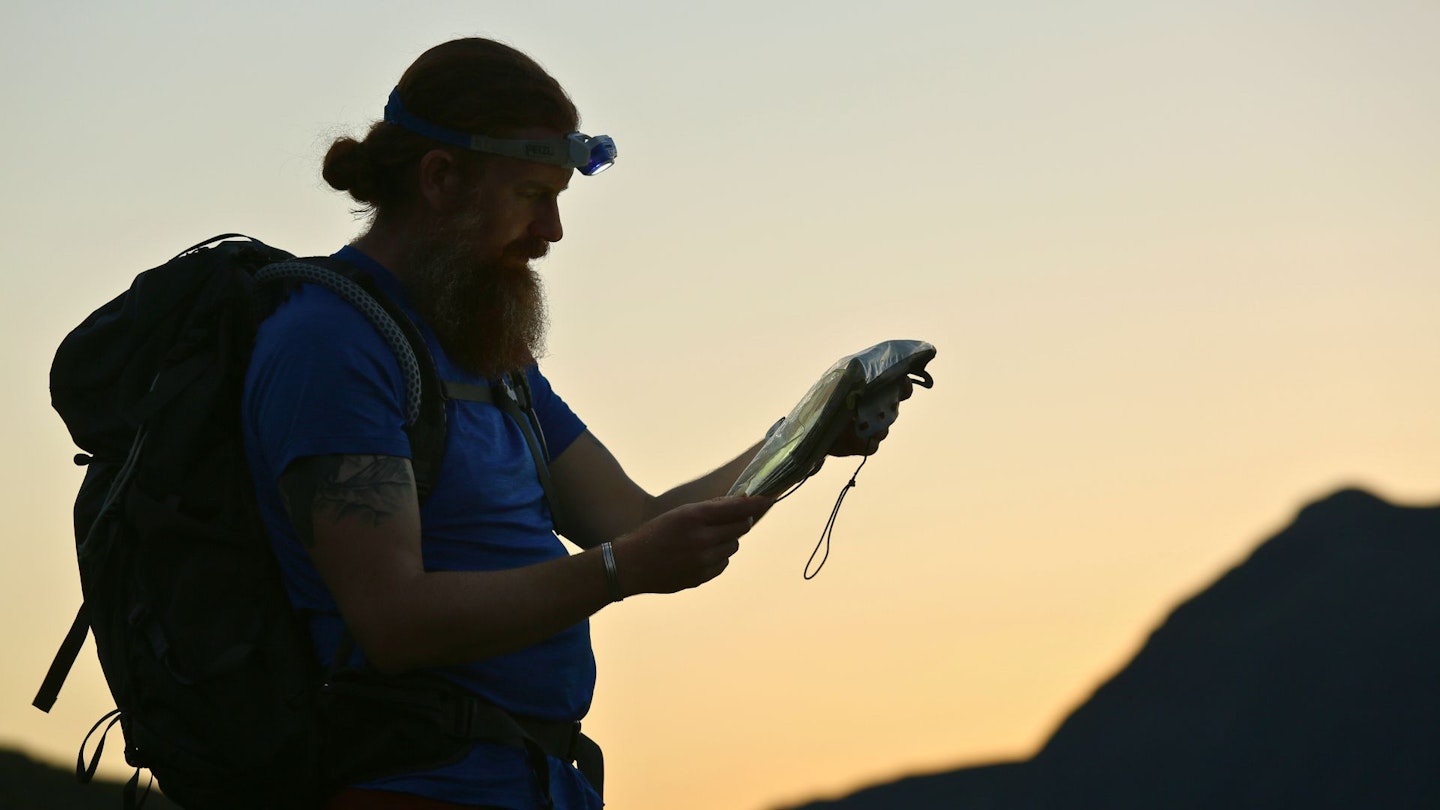 Night hiker reading a map