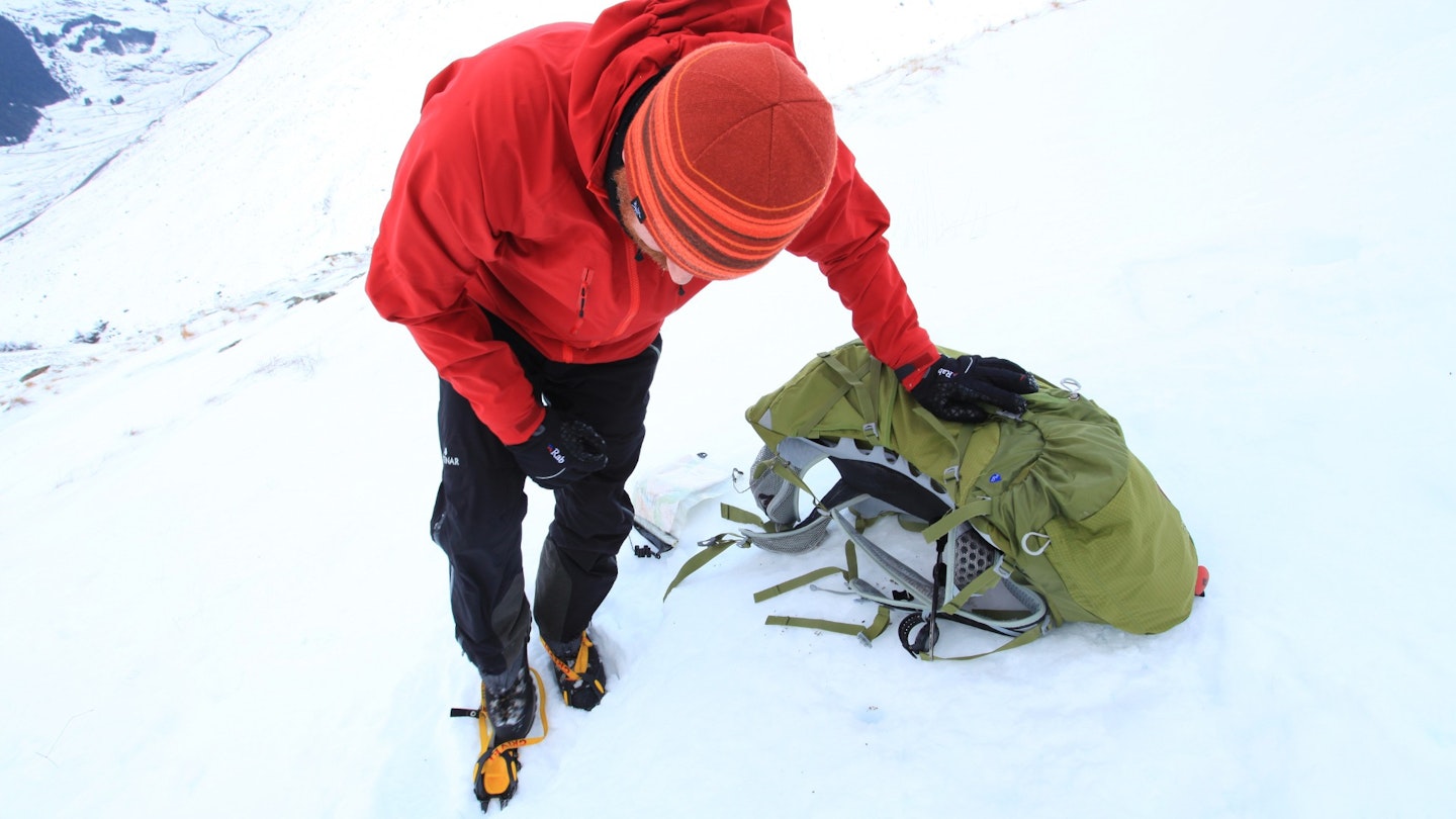 Hiker putting on crampons