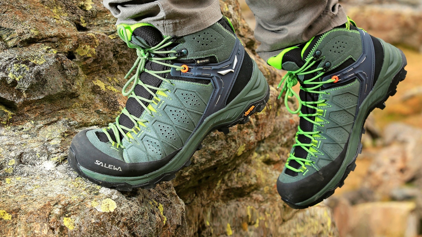 Climbing a rock in hiking boots