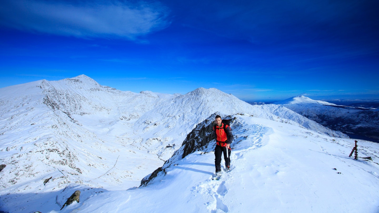 Hiker with an ice axe, summit of Yr Aran