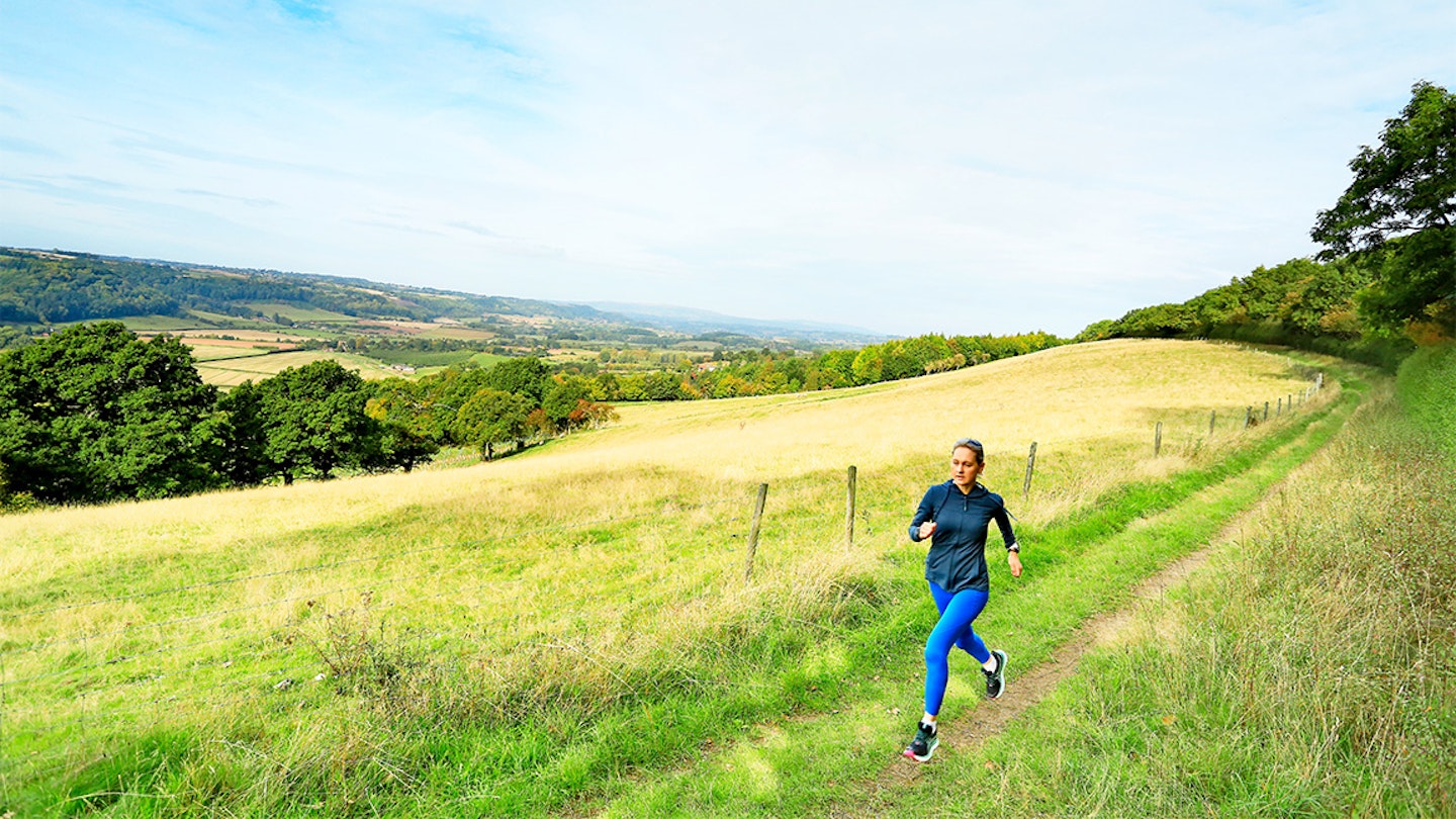 woman runs through a field