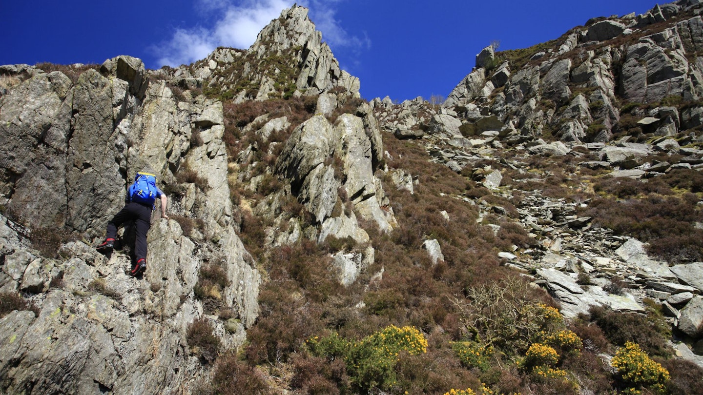 Hiker climbing Grade 2 scramble, Wales