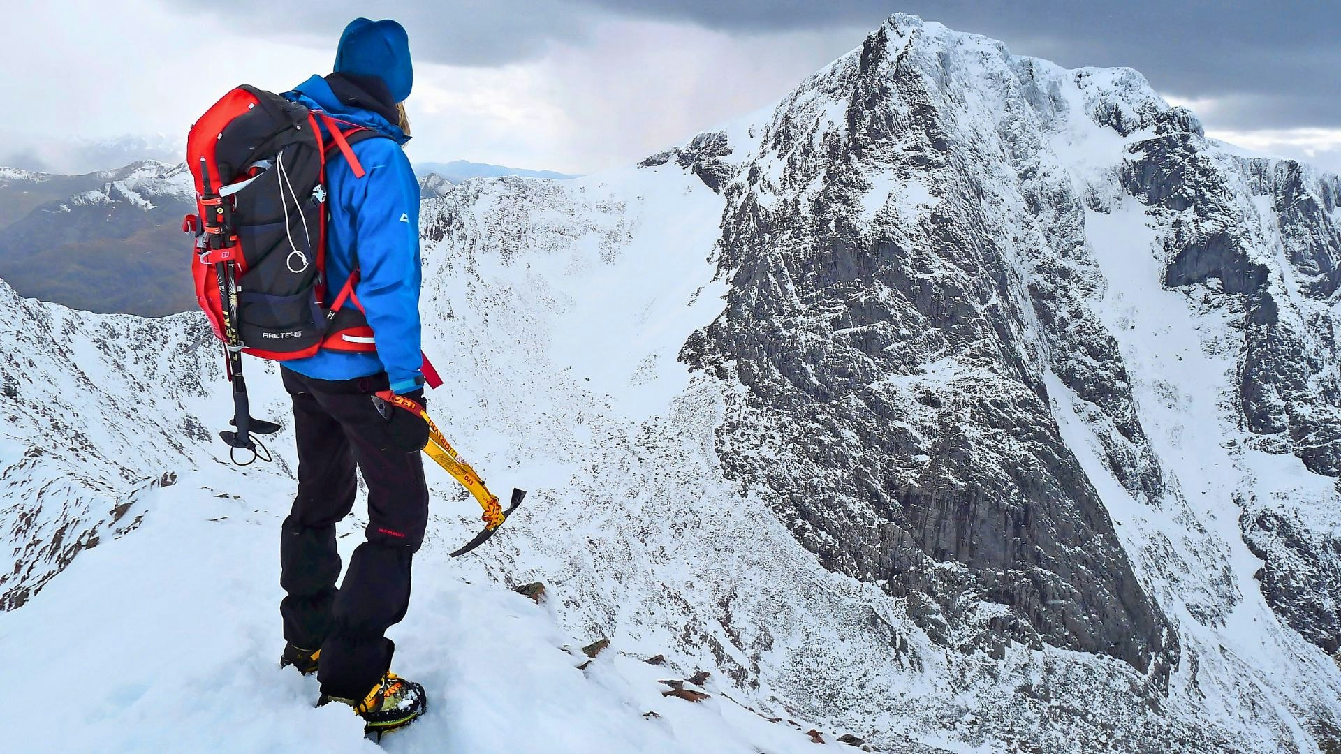 Hiker climbing ben nevis in winter