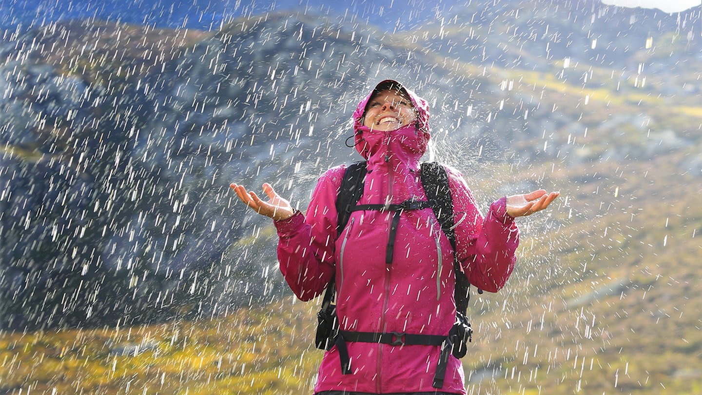 Female hiker wearing a waterproof jacket in the rain