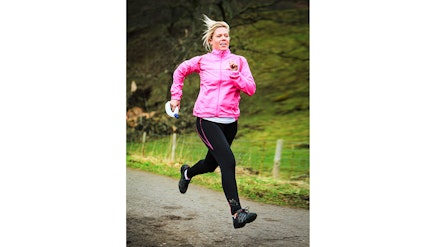 woman runs with water bottle