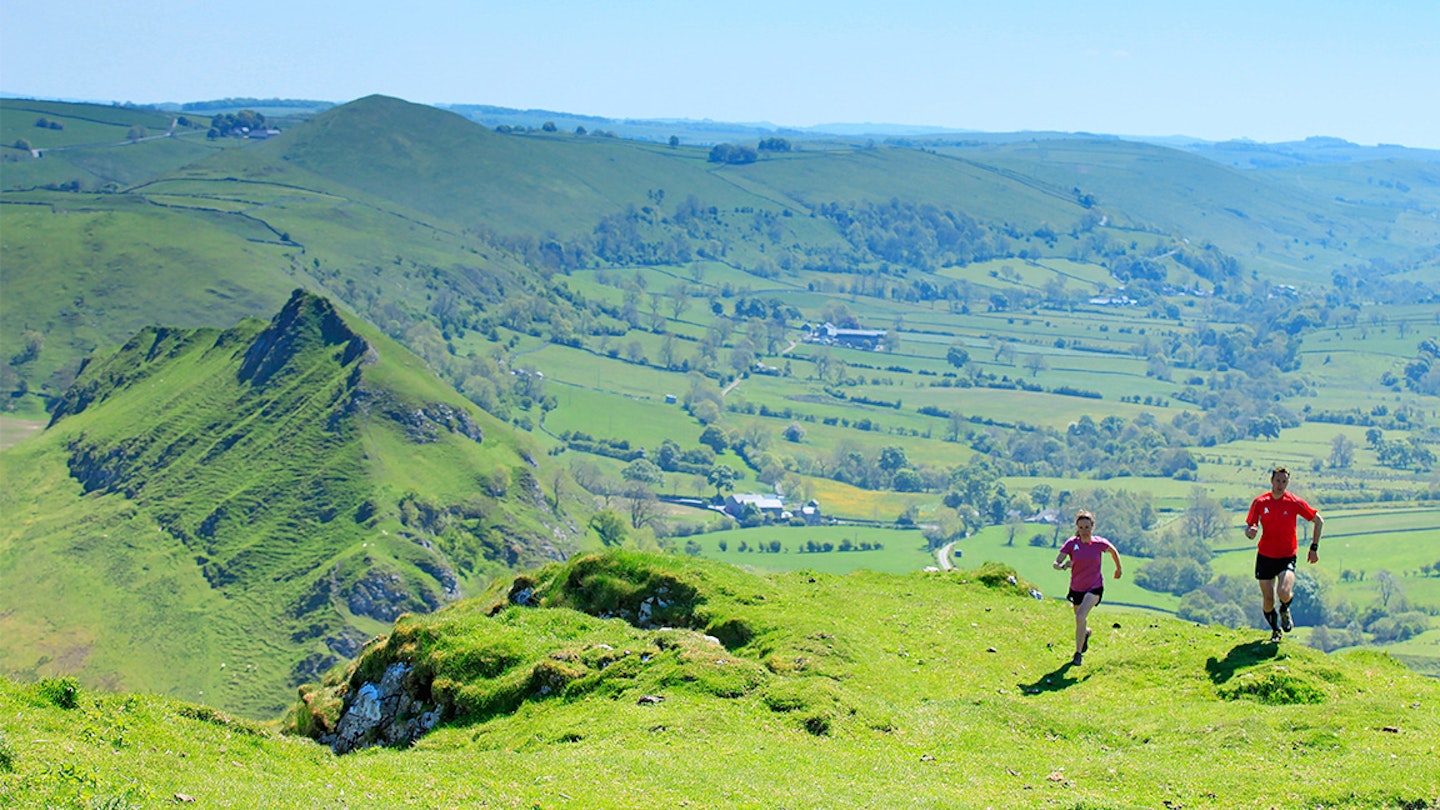 two runners run along fields